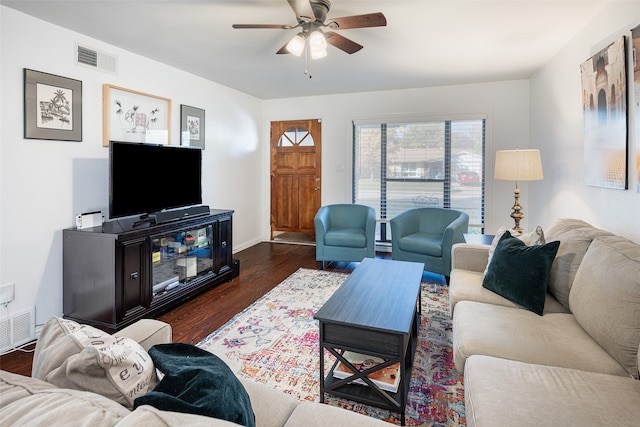 living room with dark wood-type flooring and ceiling fan