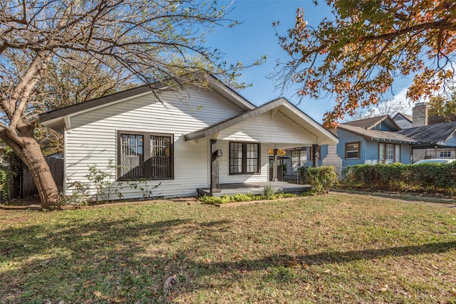 view of front of property with covered porch and a front yard