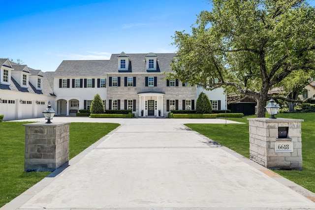 view of front of property with a garage and a front yard