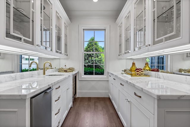 interior space featuring white cabinetry, sink, ornamental molding, and light stone countertops