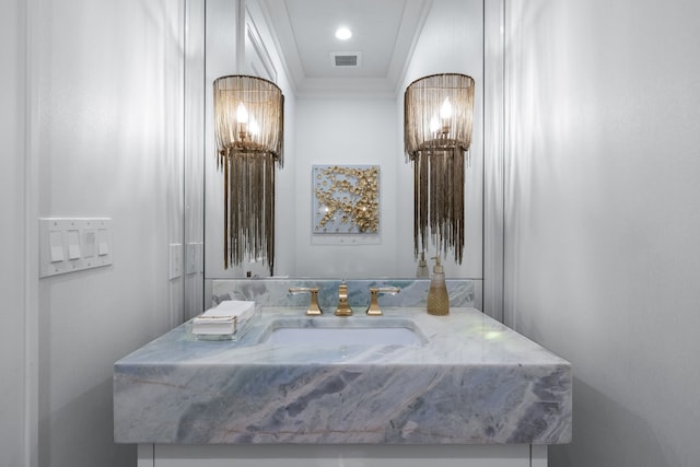 bathroom with ornamental molding and vanity