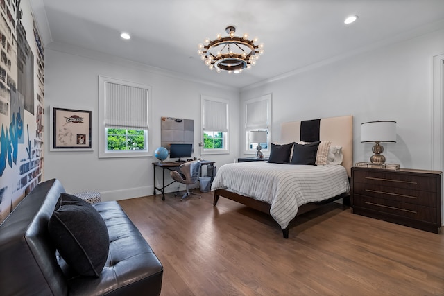 bedroom featuring an inviting chandelier, ornamental molding, and hardwood / wood-style floors