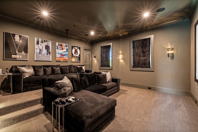 carpeted cinema room featuring crown molding