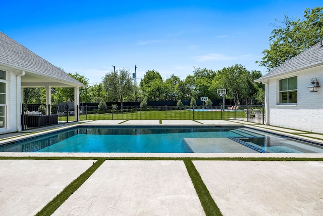 view of swimming pool featuring a yard and a patio area