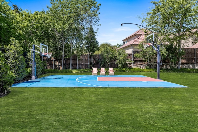 view of basketball court with a lawn