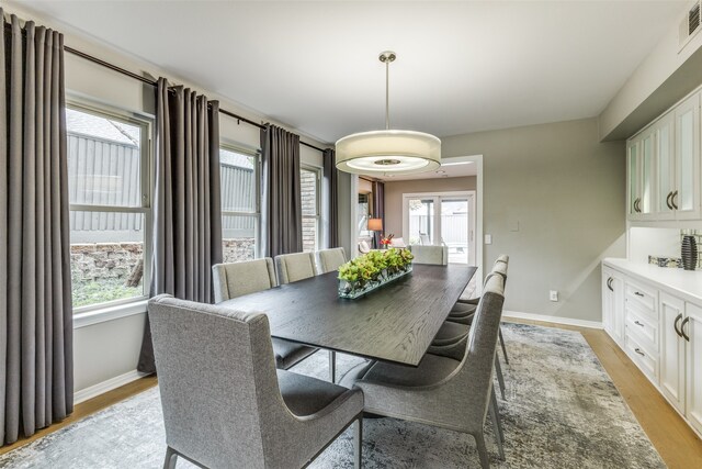 dining room featuring a healthy amount of sunlight and light hardwood / wood-style flooring