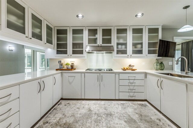 kitchen featuring white cabinetry, sink, pendant lighting, and stainless steel gas stovetop