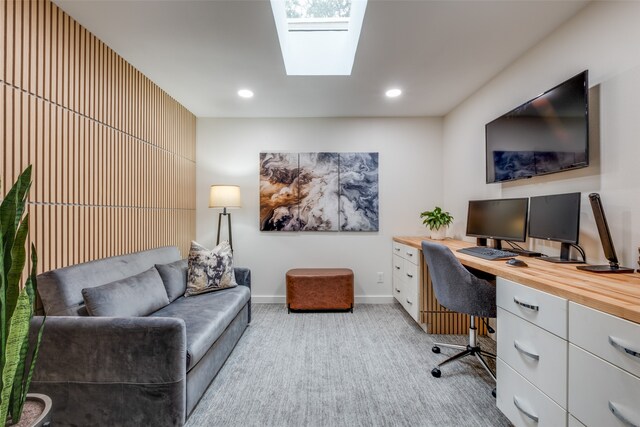 office area featuring a skylight and light colored carpet