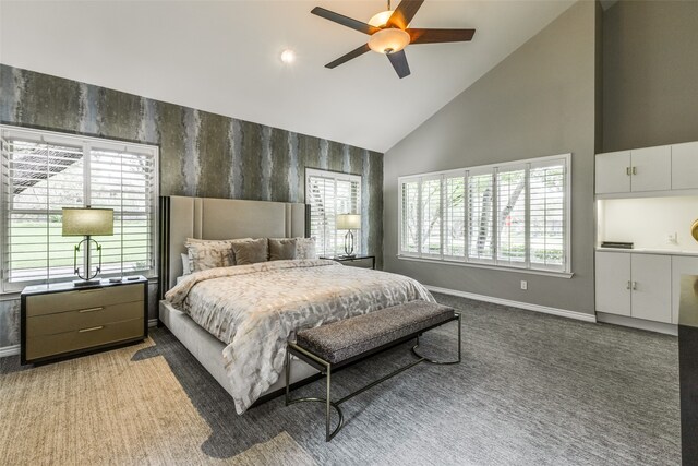 carpeted bedroom with high vaulted ceiling and ceiling fan