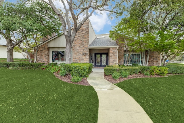 view of front of home with a front lawn and french doors