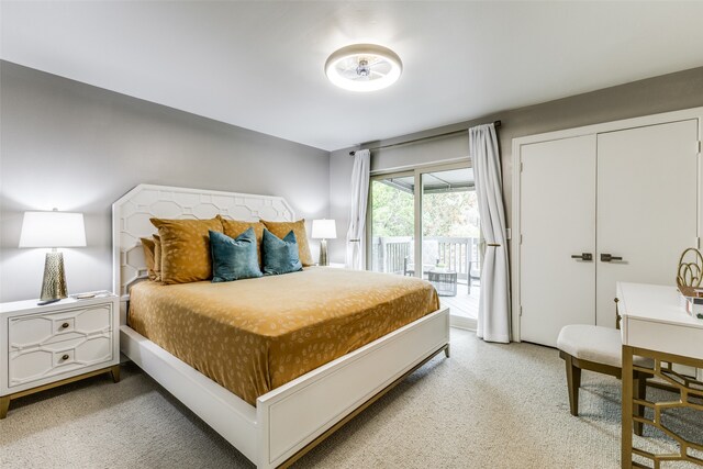 bedroom featuring access to outside, carpet flooring, and a closet