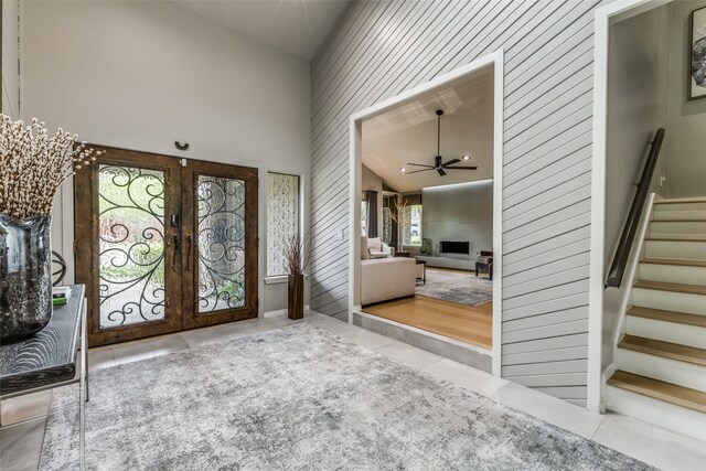 foyer entrance featuring french doors, high vaulted ceiling, plenty of natural light, and ceiling fan