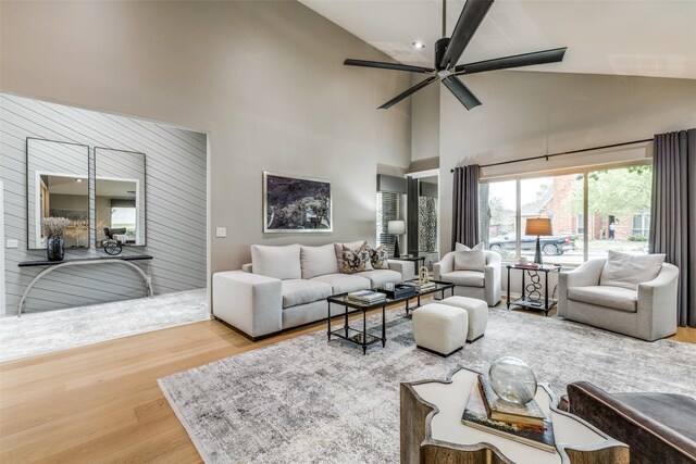 living room with wood-type flooring, high vaulted ceiling, and ceiling fan