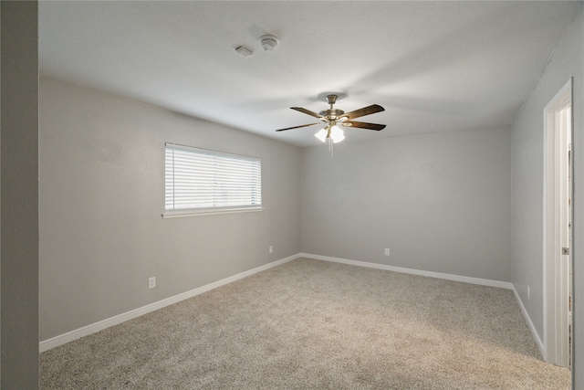 spare room featuring ceiling fan and carpet floors