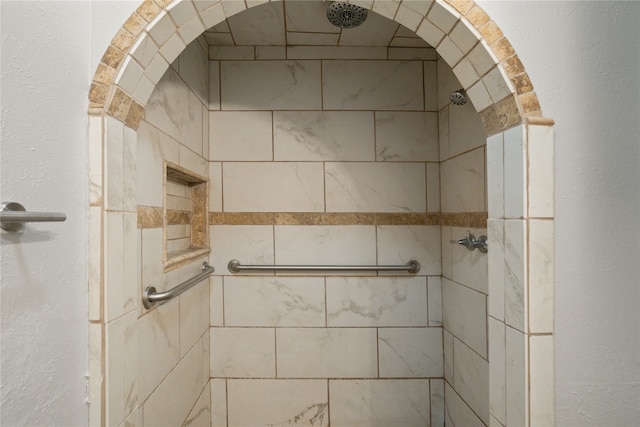 interior details featuring tiled shower