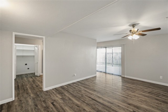 empty room featuring ceiling fan and dark wood-type flooring