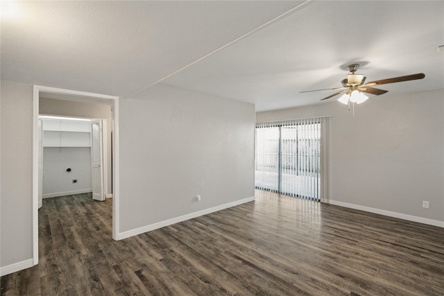 spare room with dark wood-type flooring and ceiling fan