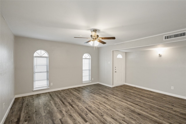 spare room with ceiling fan and dark hardwood / wood-style flooring