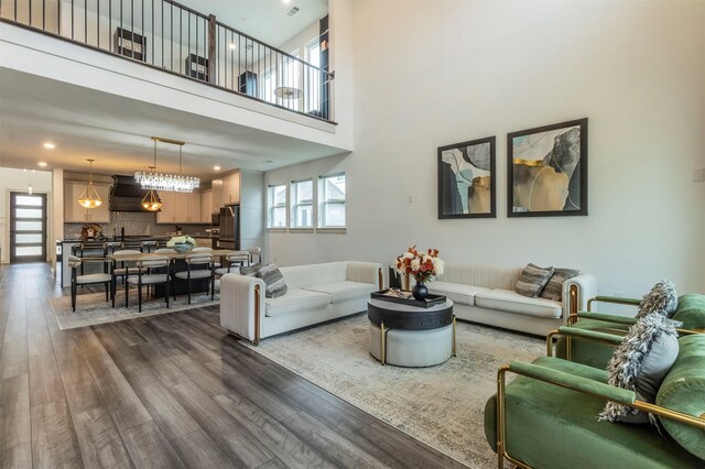 living room featuring hardwood / wood-style floors and a towering ceiling