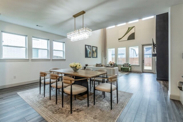 dining room featuring dark hardwood / wood-style flooring and an inviting chandelier