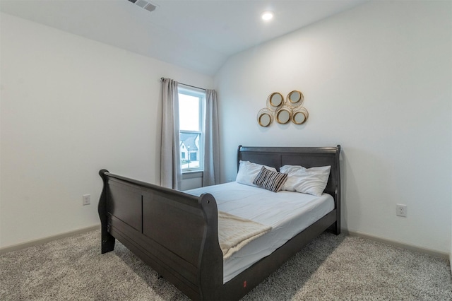 bedroom featuring light carpet and lofted ceiling