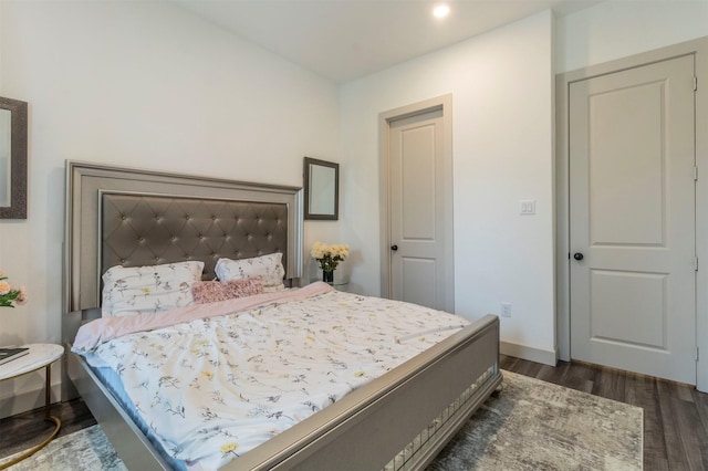 bedroom with dark wood-type flooring