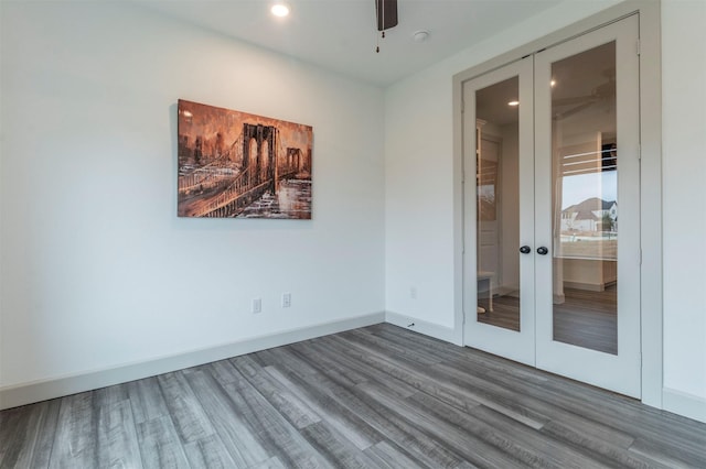 unfurnished room with hardwood / wood-style floors, ceiling fan, and french doors