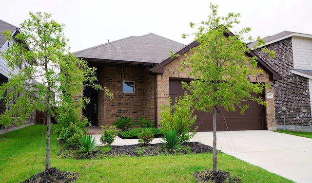 view of front of home with a garage and a front lawn