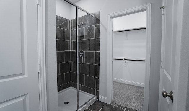 bathroom with tile patterned flooring and walk in shower