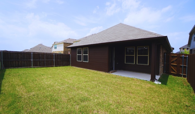 rear view of house featuring a lawn and a patio area