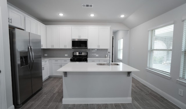 kitchen with sink, dark hardwood / wood-style floors, a center island with sink, white cabinets, and appliances with stainless steel finishes