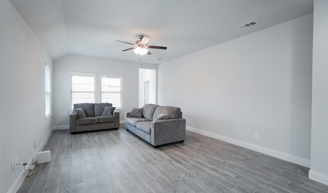 living room featuring ceiling fan, hardwood / wood-style floors, and lofted ceiling