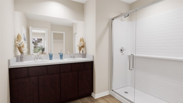 bathroom featuring hardwood / wood-style flooring, vanity, and walk in shower