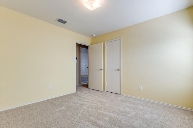 unfurnished room with light colored carpet