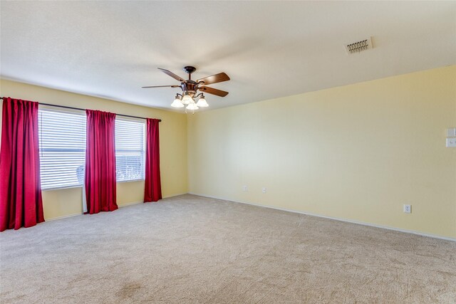 unfurnished room with ceiling fan and light colored carpet