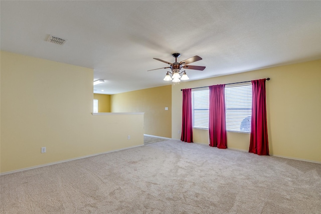 unfurnished room featuring light carpet and ceiling fan