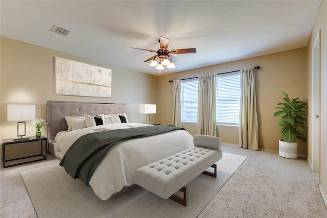 bedroom with ceiling fan and light colored carpet