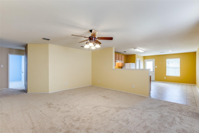 carpeted empty room featuring ceiling fan