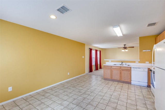 kitchen with ceiling fan, sink, white appliances, and kitchen peninsula