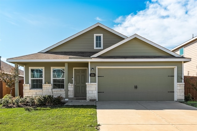 view of front of property featuring a garage and a front yard