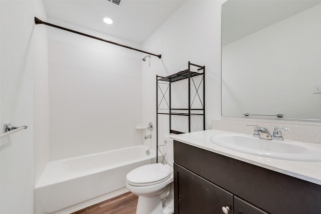 full bathroom with hardwood / wood-style flooring, vanity,  shower combination, and toilet