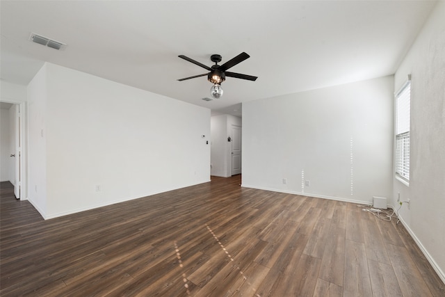 empty room featuring ceiling fan and dark wood-type flooring