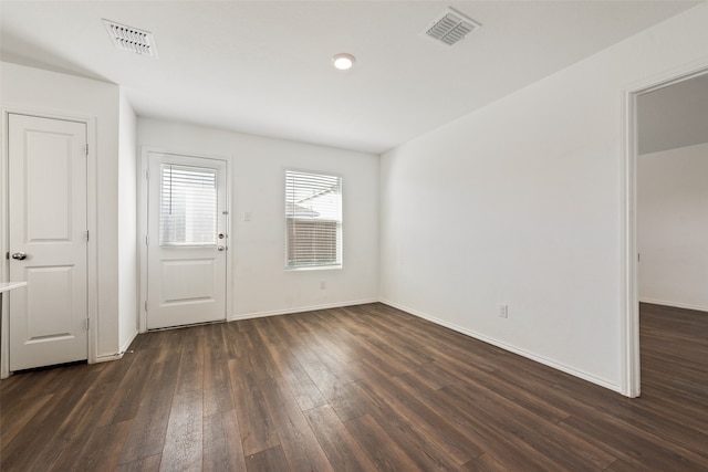 spare room with dark hardwood / wood-style flooring