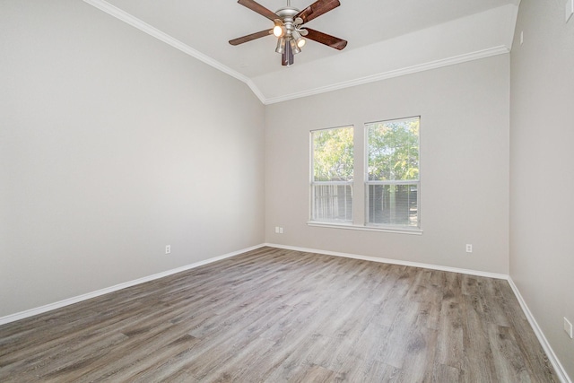 unfurnished room featuring crown molding, vaulted ceiling, light hardwood / wood-style floors, and ceiling fan