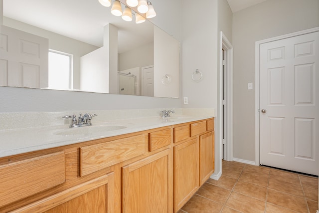 bathroom featuring tile patterned flooring, vanity, and an enclosed shower