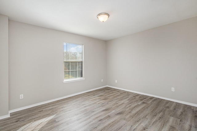 spare room with hardwood / wood-style flooring