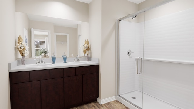 bathroom with hardwood / wood-style floors, vanity, and walk in shower