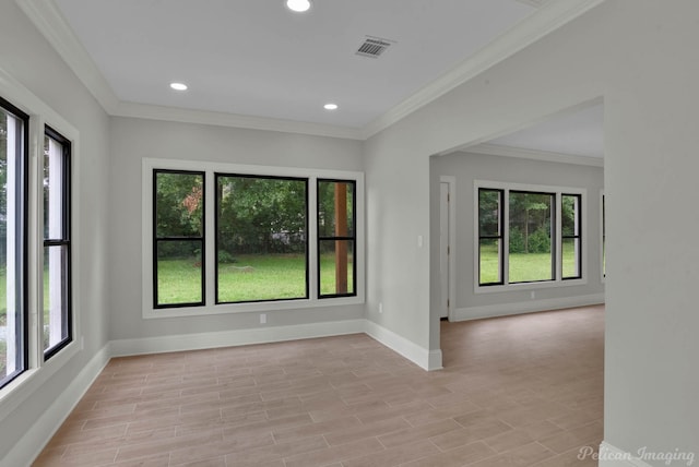 unfurnished room featuring light wood-type flooring and crown molding