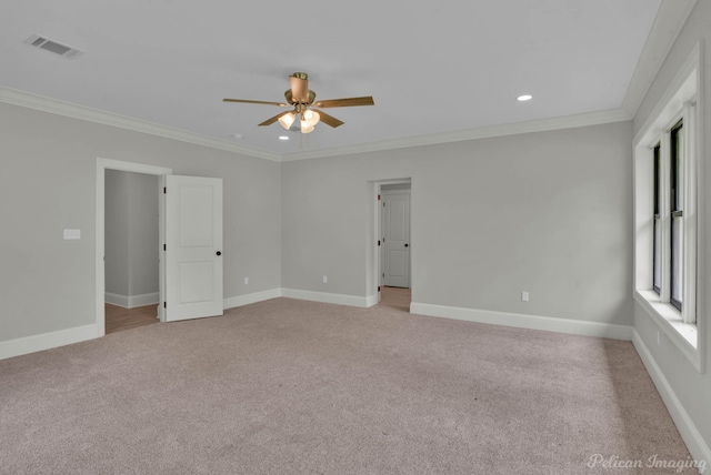 carpeted empty room featuring ceiling fan and crown molding