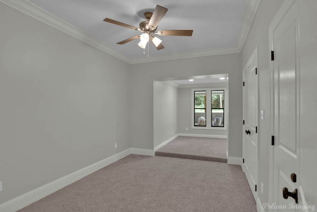 carpeted empty room with ceiling fan and ornamental molding